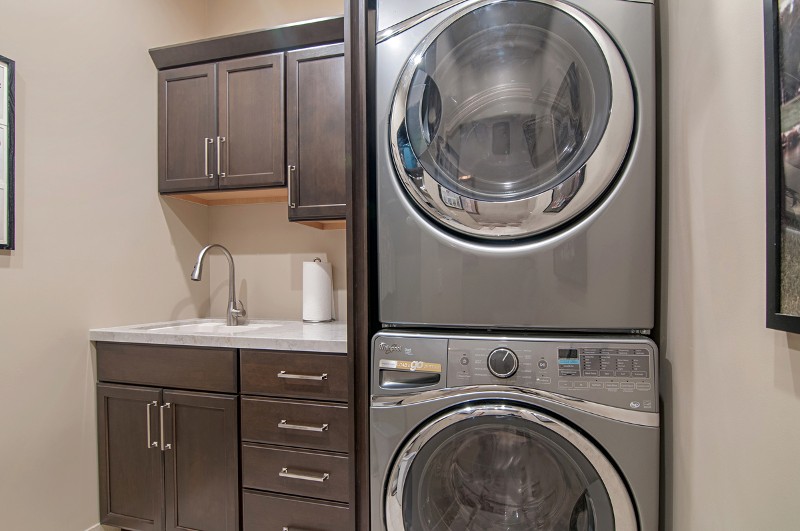 A stacked washer/drier unit in the laundry room
