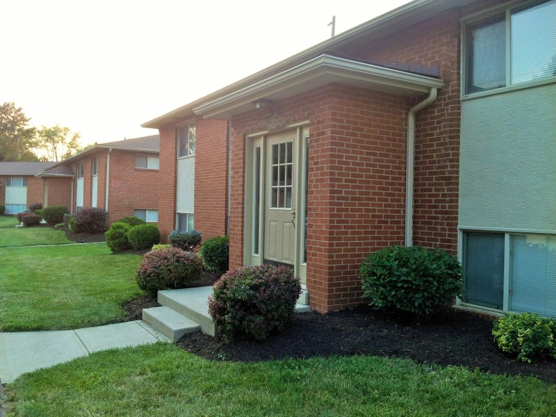 The front entrance door to an apartment with concrete steps.