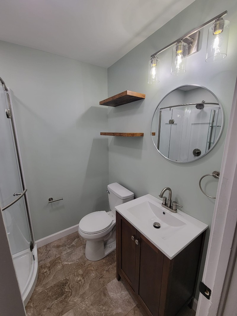 A bathroom makeover with new drywall and luxury vinyl flooring.