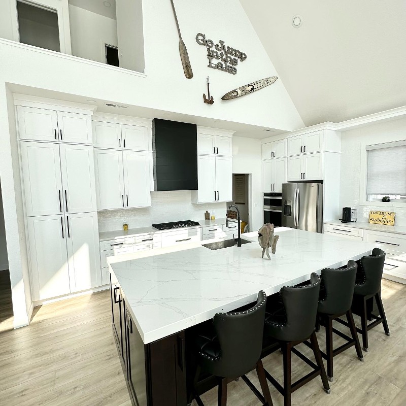A kitchen with white counters.