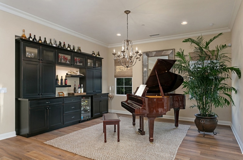removeled entertaining room with wet bar and grand piano