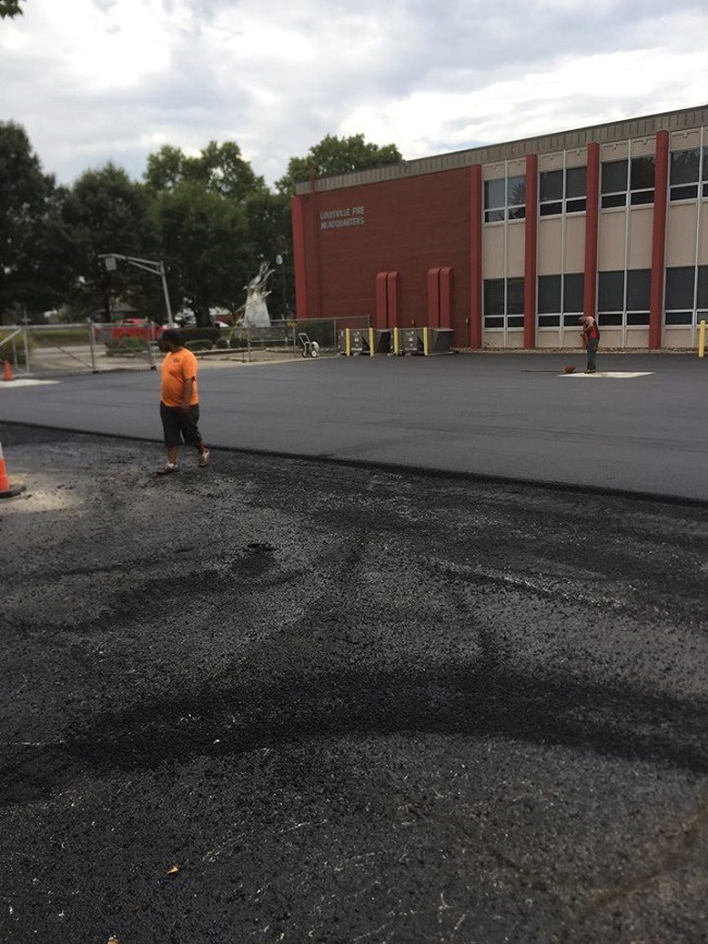 An asphalt parking lot at a school.