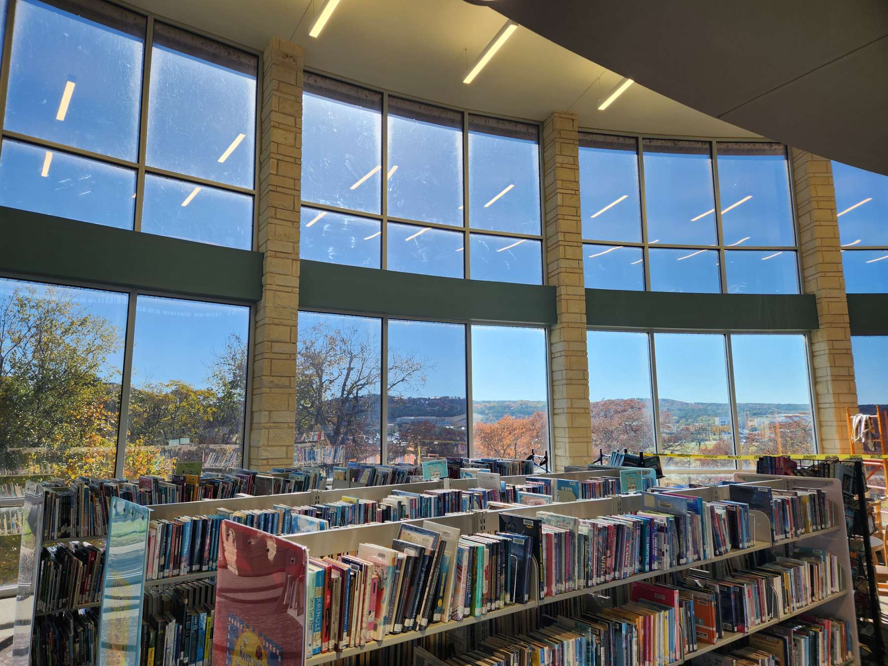 books on shelves in front of open windowed area