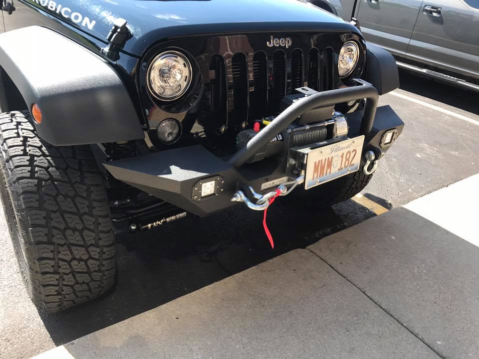 A Jeep with a large add-on grill.