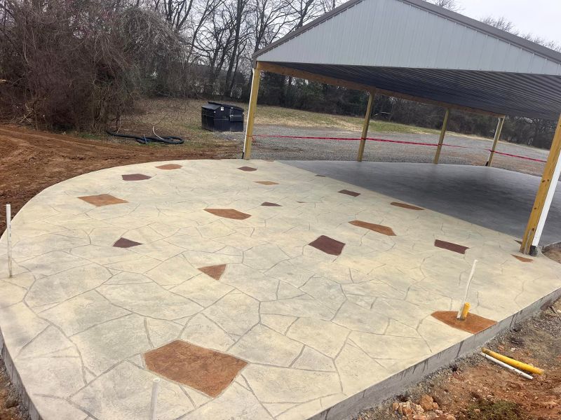 Colored and stamped concrete next to an outdoor shelter.