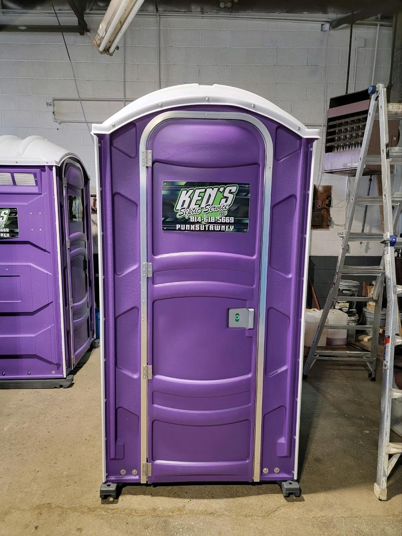 Two purple portable toilets.