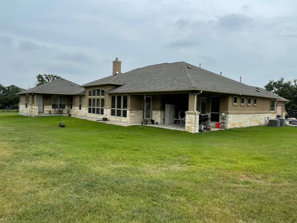 A modern home with gray shingled roofing.