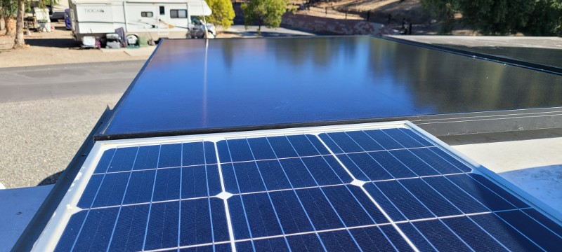 The view of an RV top with solar panels.