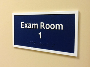An interior sign for Exam Room 1.
