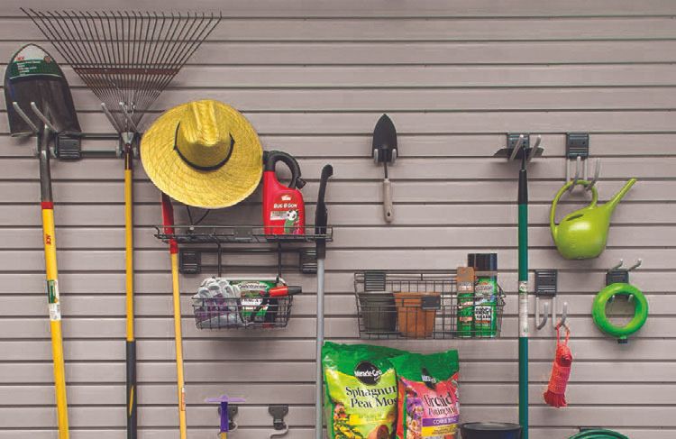 Gardening tools and accessories hanging from a custom garage storage system from TGG Garage.