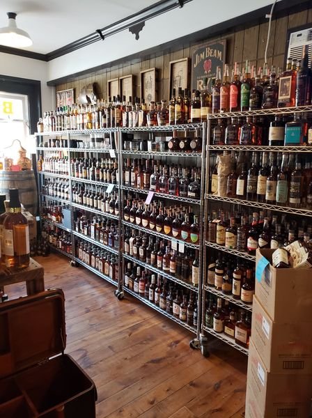 A large wall full of bottles of bourbon and other spirits.