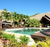 A swimming pool surrounded by palm trees