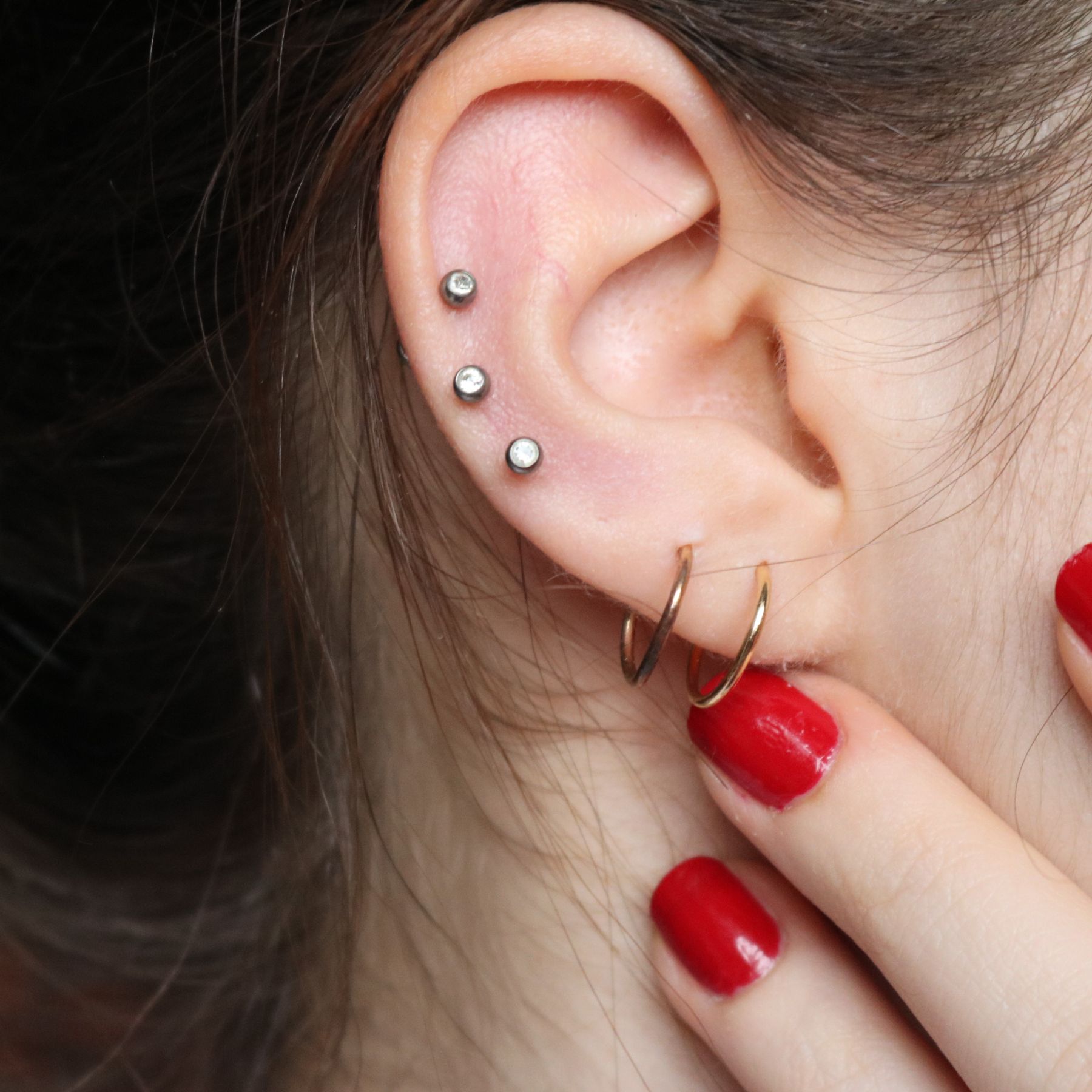 Right ear with two lobe piercings and three cartilage piercings.