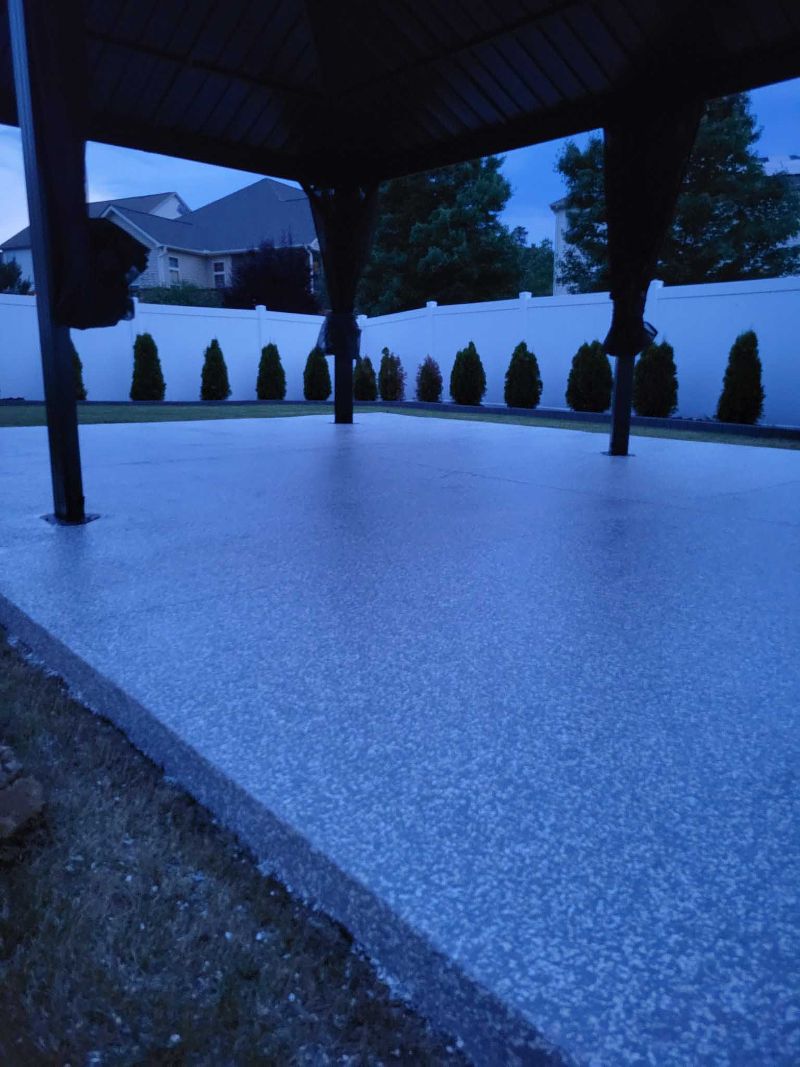 A large epoxy flooring underneath a covered patio.