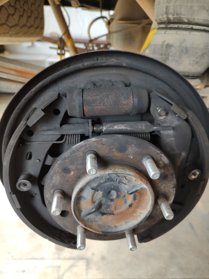 Brake assembly coated in rust and dirt
