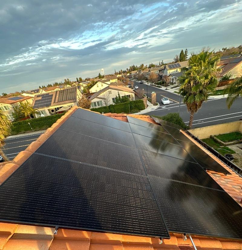 Solar panels on a shingled roof.