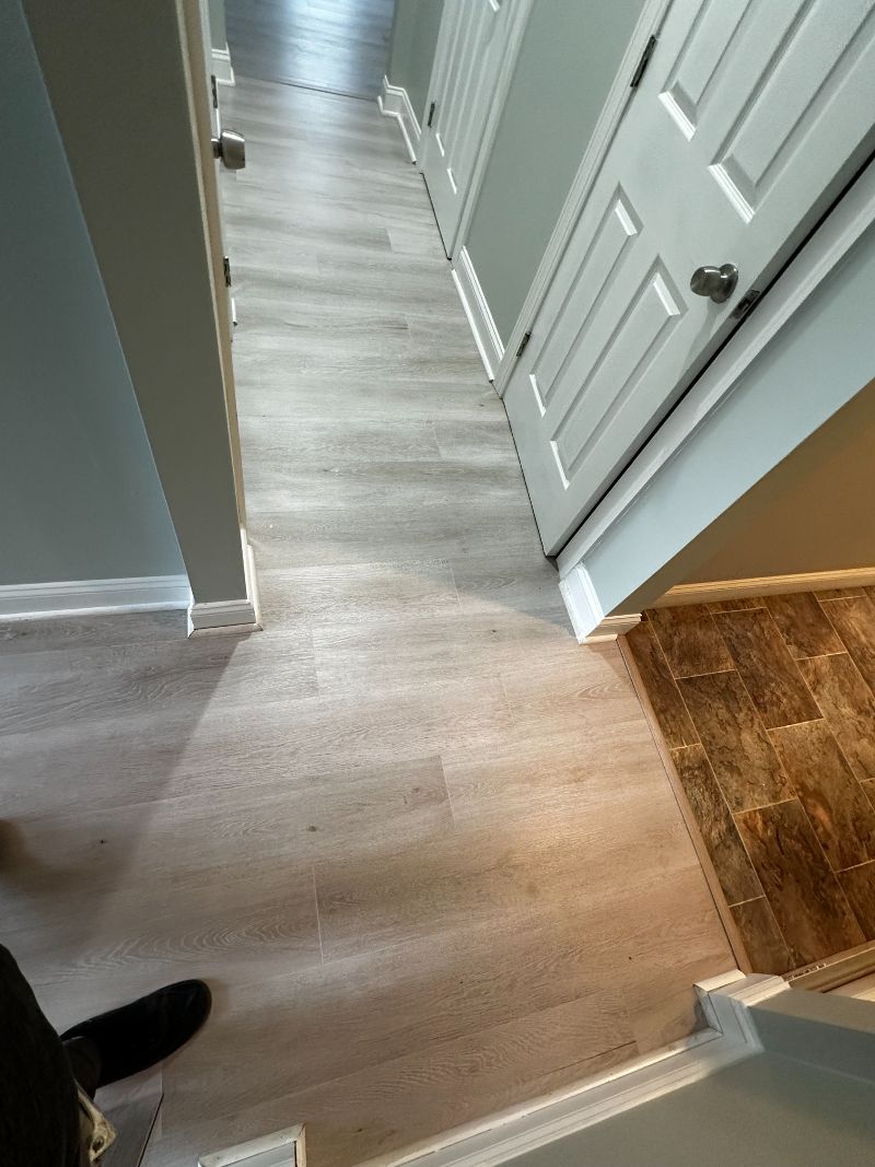 Foyer in a home with a grey hardwood floor.