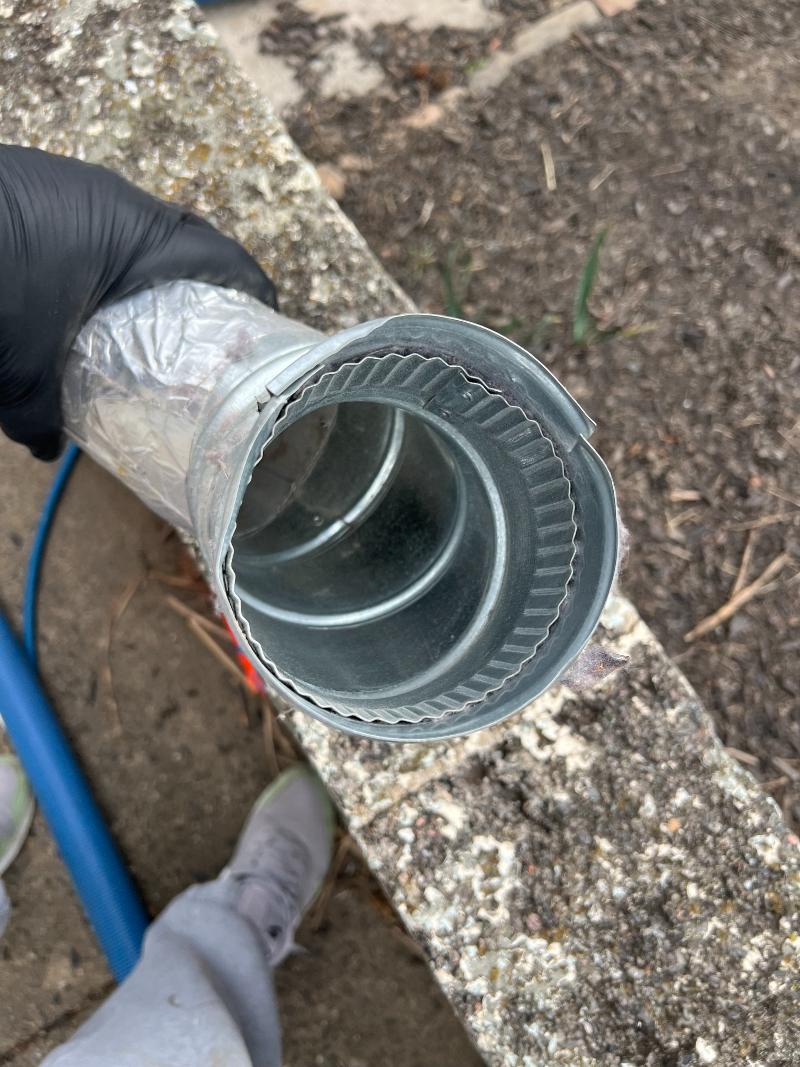 The view looking down into a clean dryer vent hose.