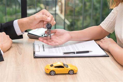 A man hands off new car keys to a customer.