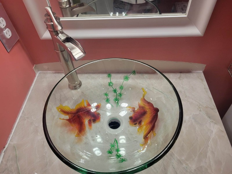 A modern sink with a granite countertop.