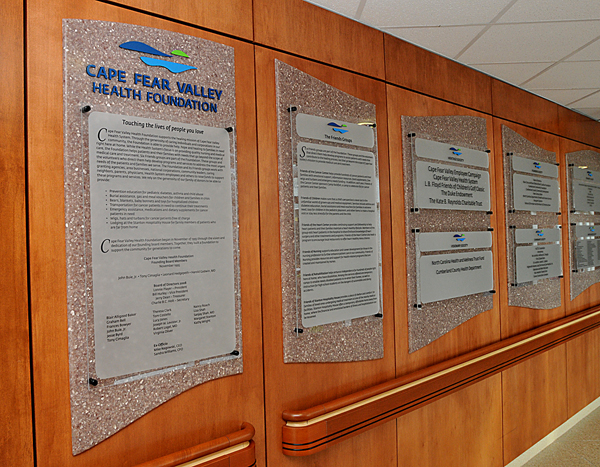 A row of interior informational plaques for Cape Fear Valley Health Department.