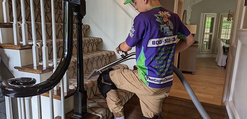 Employee cleaning carpeted stairs