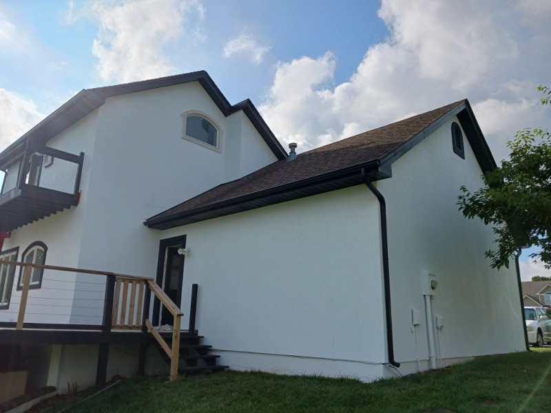 The rear of a home with a white paint job.