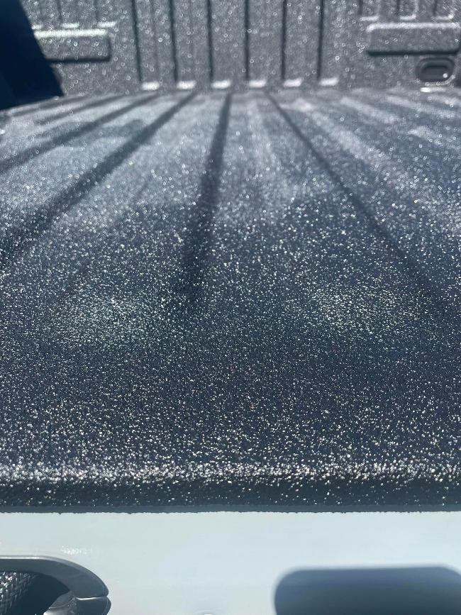 Close-up image of a black spray-on bedliner.