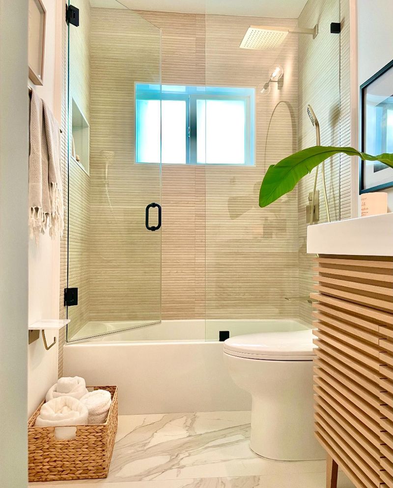 A modern bathroom with a tile flooring and a bamboo screen.