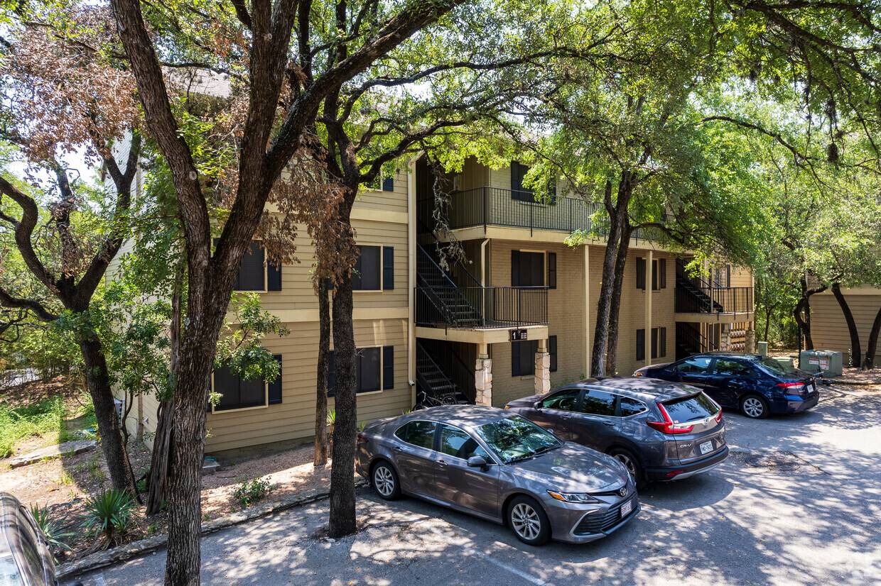 Cars parked in front of apartment units.