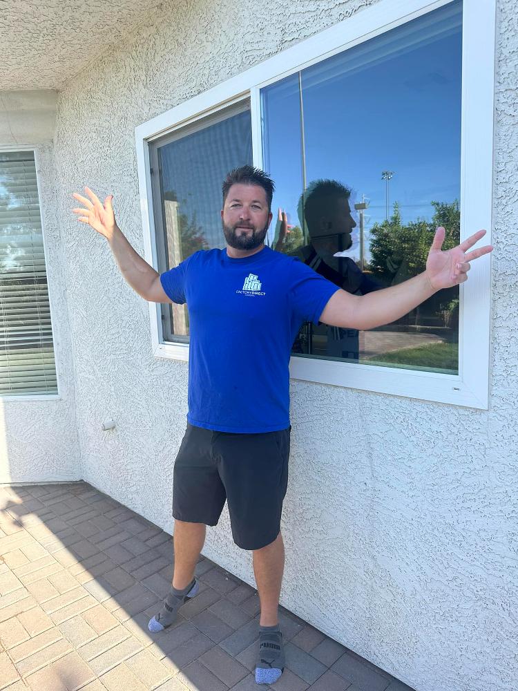 image of a team member standing in front of a window