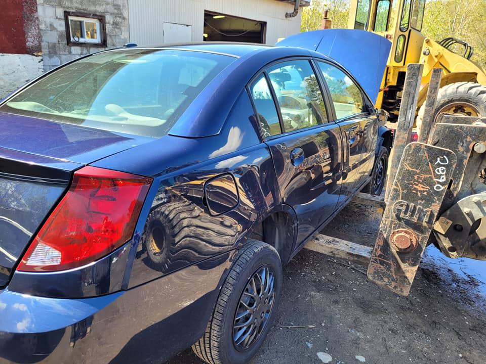 A car being lifted with a forklift