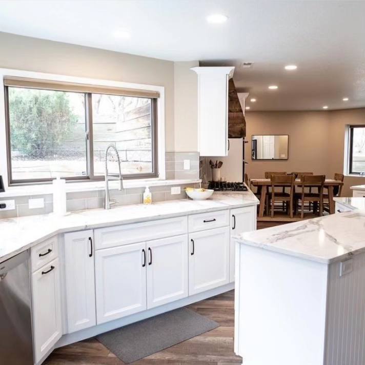 A stylish kitchen with white walls and cabinets