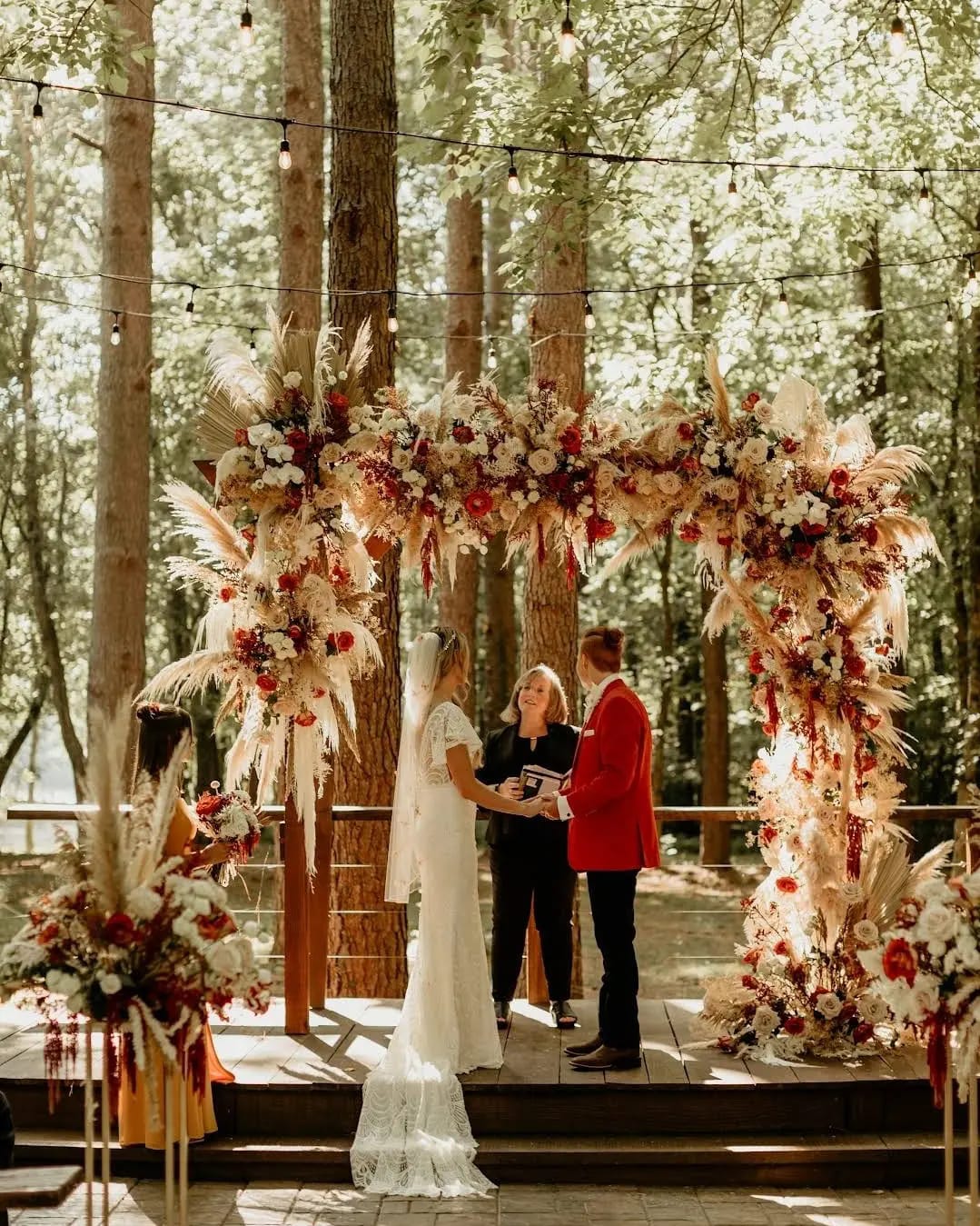 A bride and groom look at the wedding officiant during their ceremony.