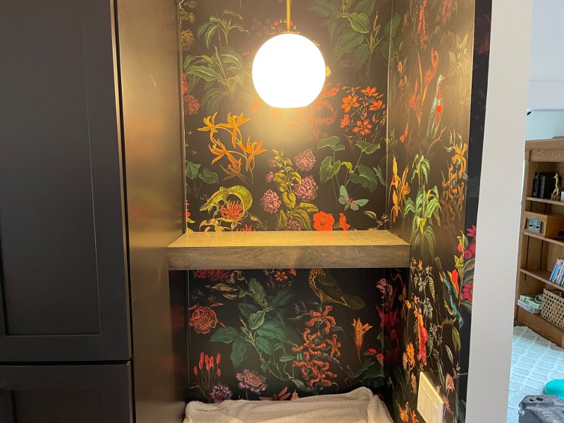 A cubby space with a colorful flower background.