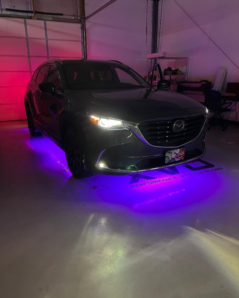 Mazda SUV with undercarriage lighting.