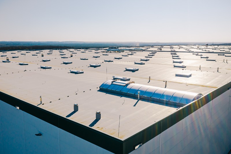 An overhead view of a large commercial facility with a flat roof.