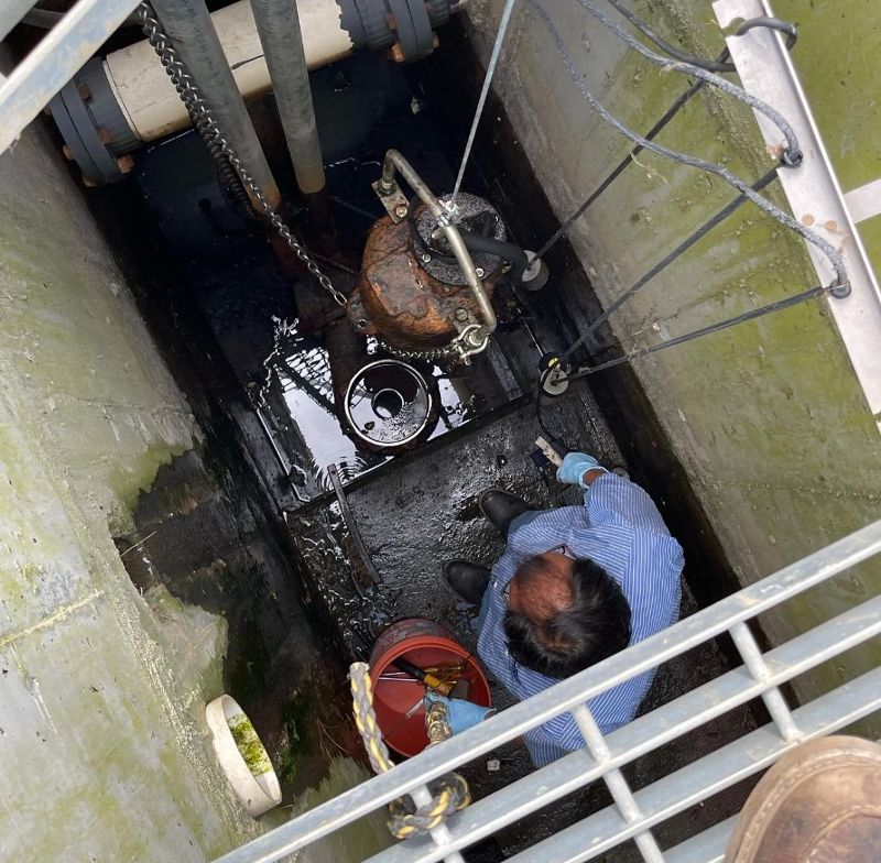 An overhead view of a man operating septic pumping equipment.