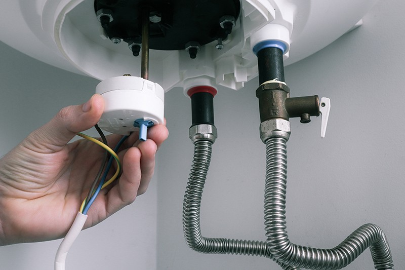 plumber working on a water heater