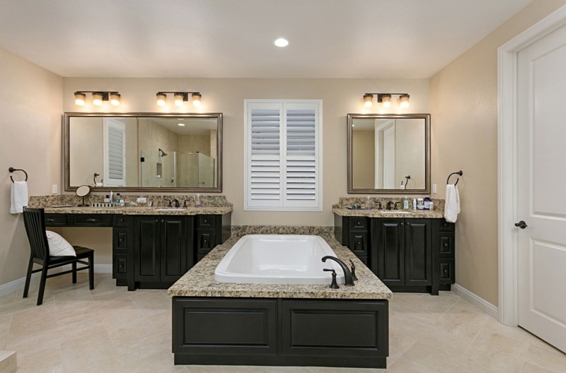 New master bath with tile floor, large soaking tub, twin vanities with granite tops