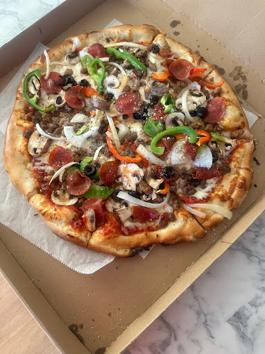 Freshly made supreme pizza, packed with toppings, and finished with a perfectly browned crust