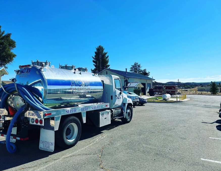 A pumper truck sits in a parking lot.