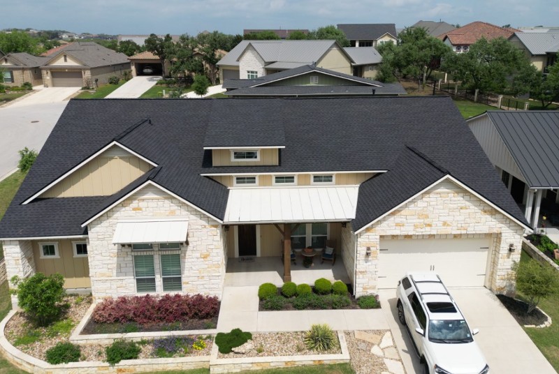 Looking down at a single-family home with a black shingle roof.