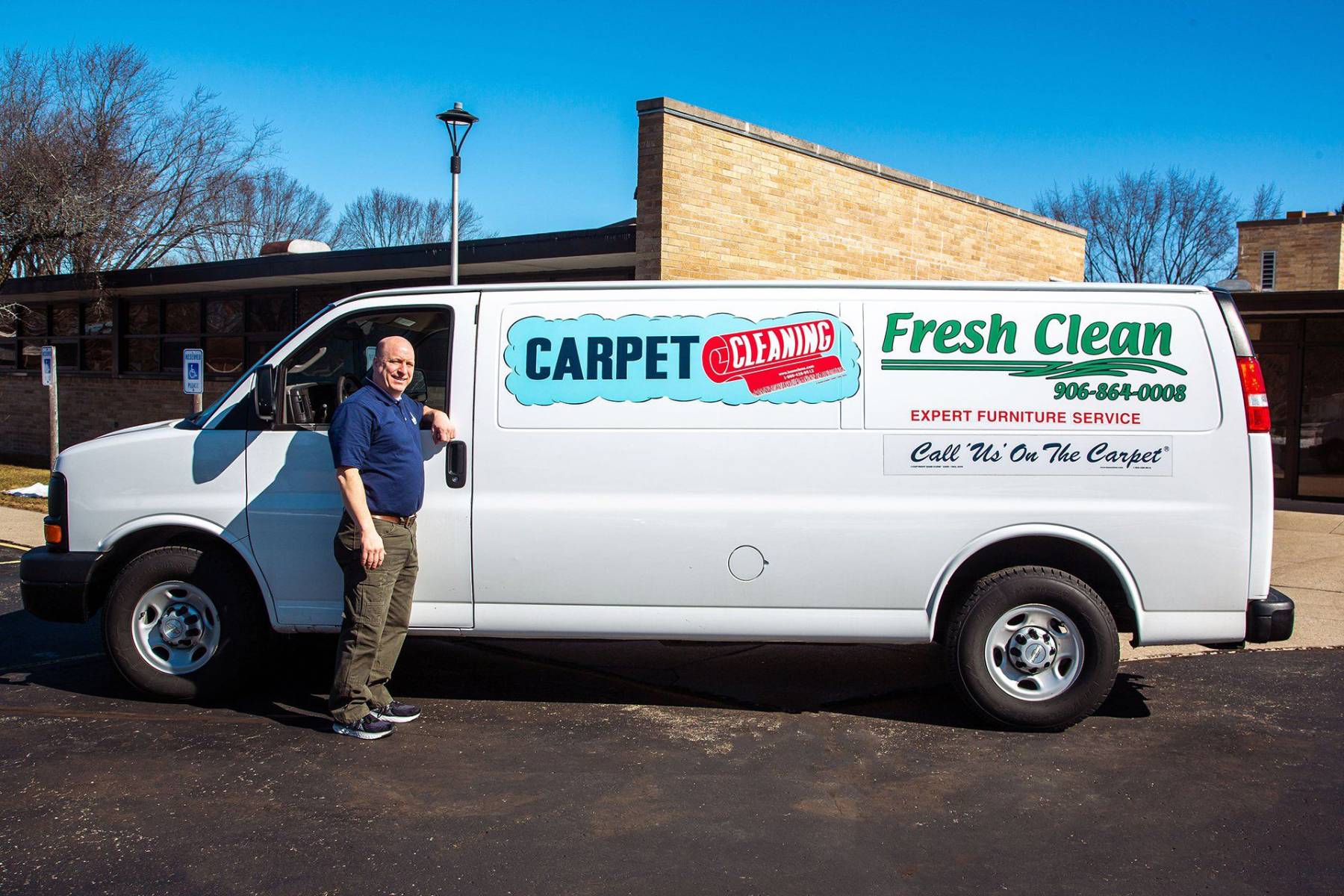 man in front of a business van