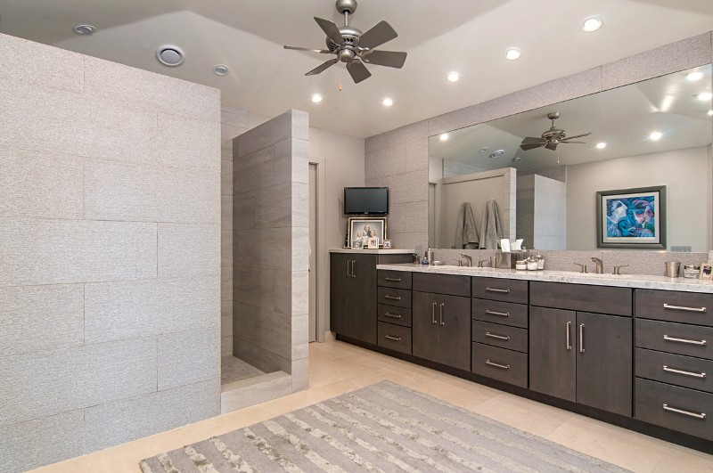Remodeled bathroom with soapstone walls, , dark cabinets, full-length mirror