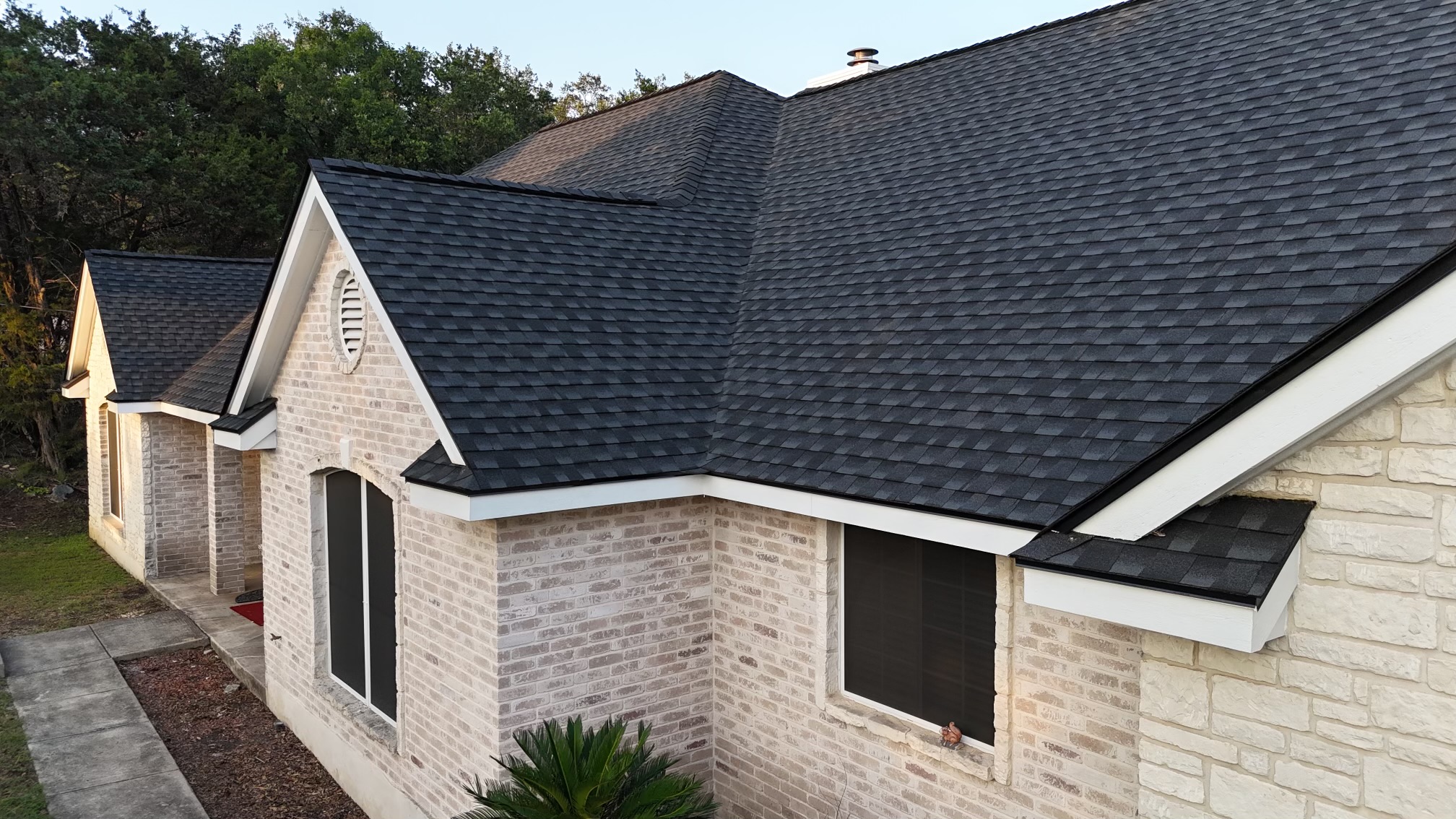 An overhead view of a large home with solar panels on the roof.