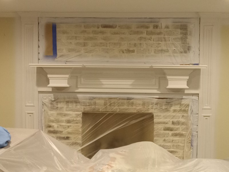 An attractive fireplace in a living area freshly painted.