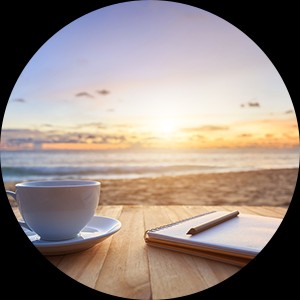 cup and tablet on beach horizon