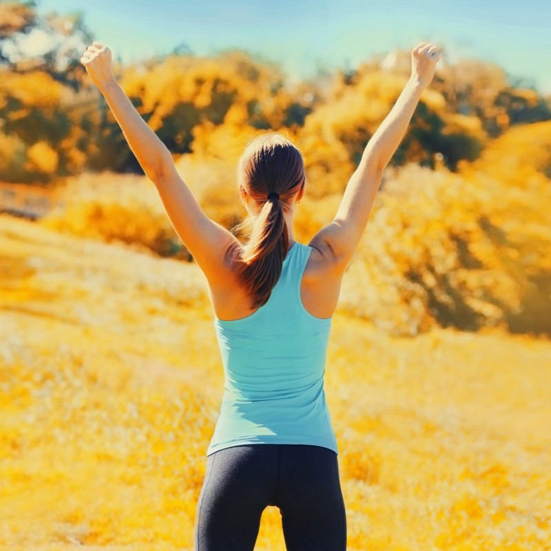 Fit woman putting her hands in the air.