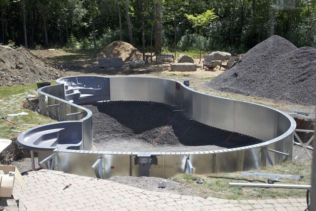 The frame of a curved-shape pool is set and ready for concrete to be poured.